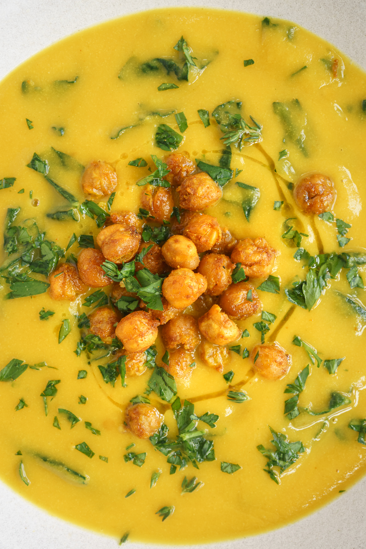 Closeup of bowl of chickpea turmeric soup with crispy chickpeas on top.