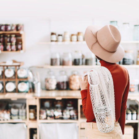 Woman shopping with a reusable bag in a zero waste shop