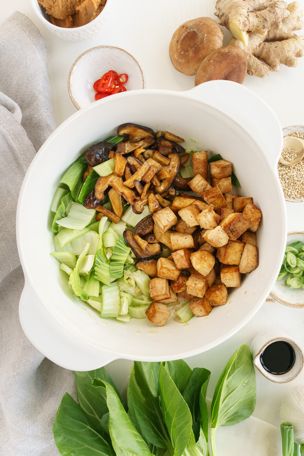 Adding mushroom and tofu to white pot