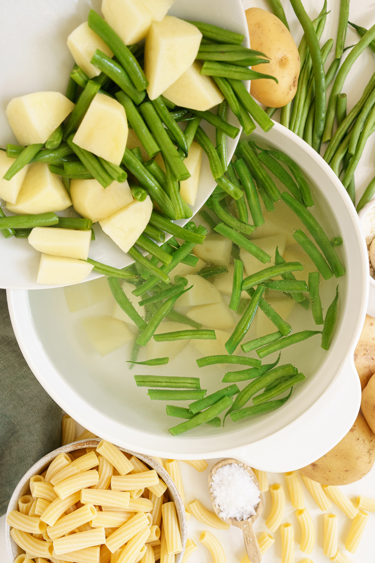 Top view of putting vegetables into a boiling pot