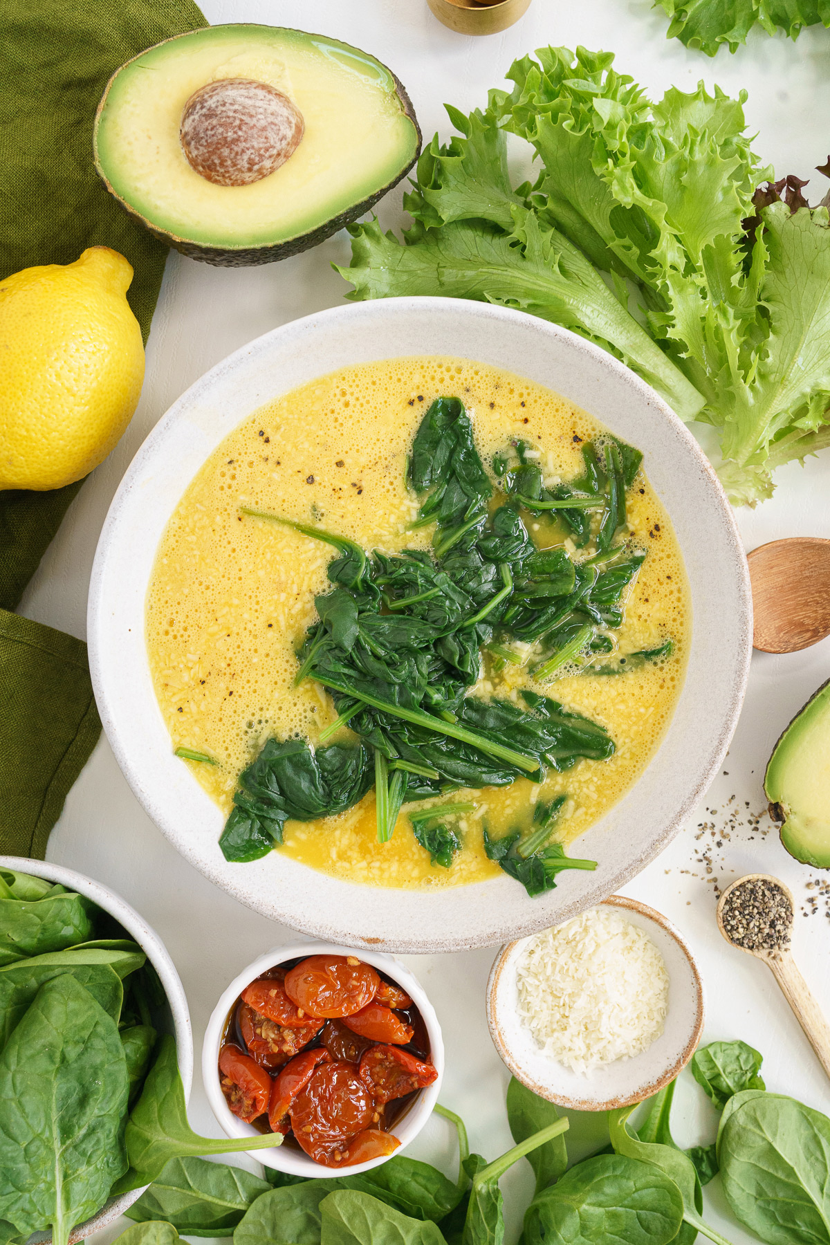 Top View of Wilted Spinach added to the Whisked Eggs