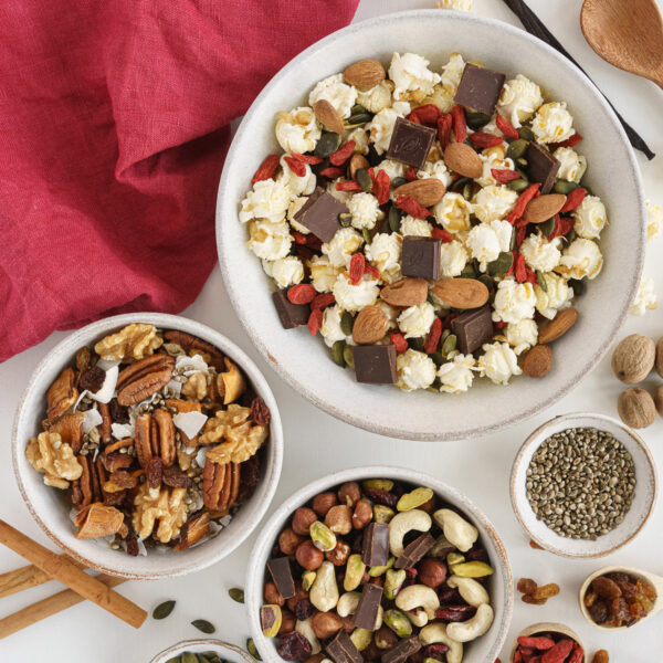 Top view of bowls filled with a variety of healthy trail mix ideas