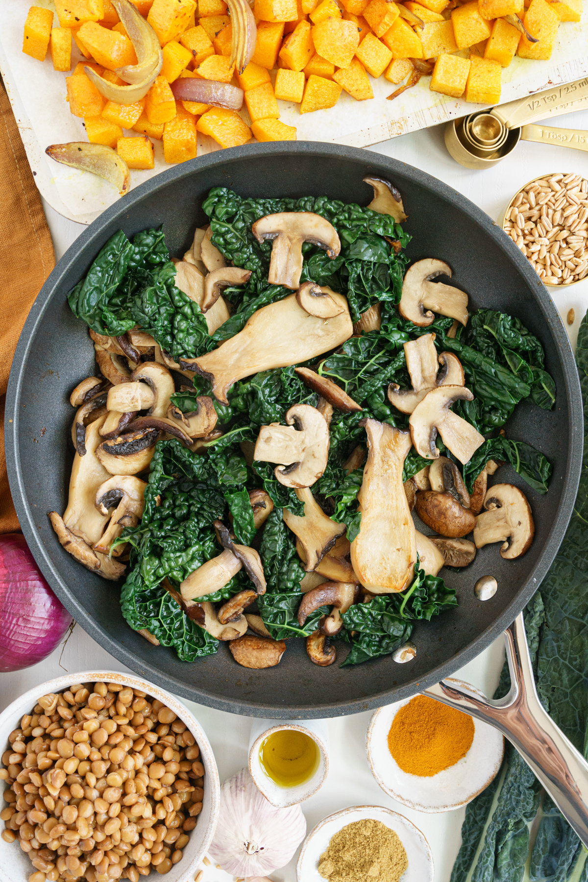 Kale added to the skillet with the mushrooms.