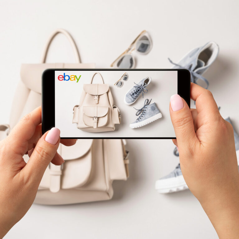 Woman taking photos of clothes with her phone to resell on eBay