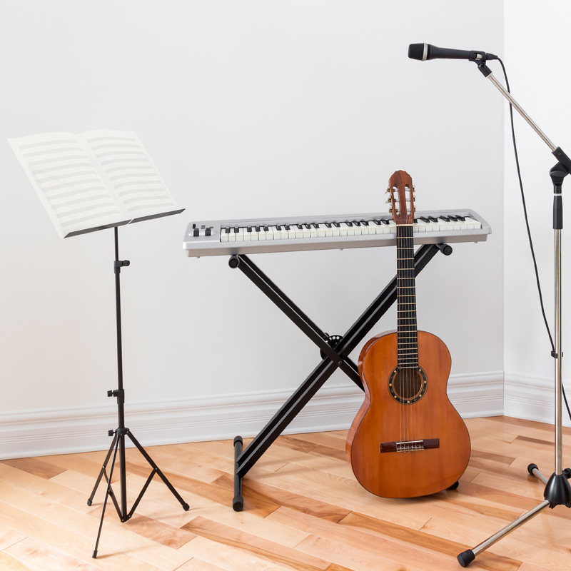 Guitar, piano, and microphone in a room