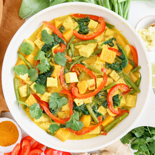 Tofu coconut curry in a white bowl.