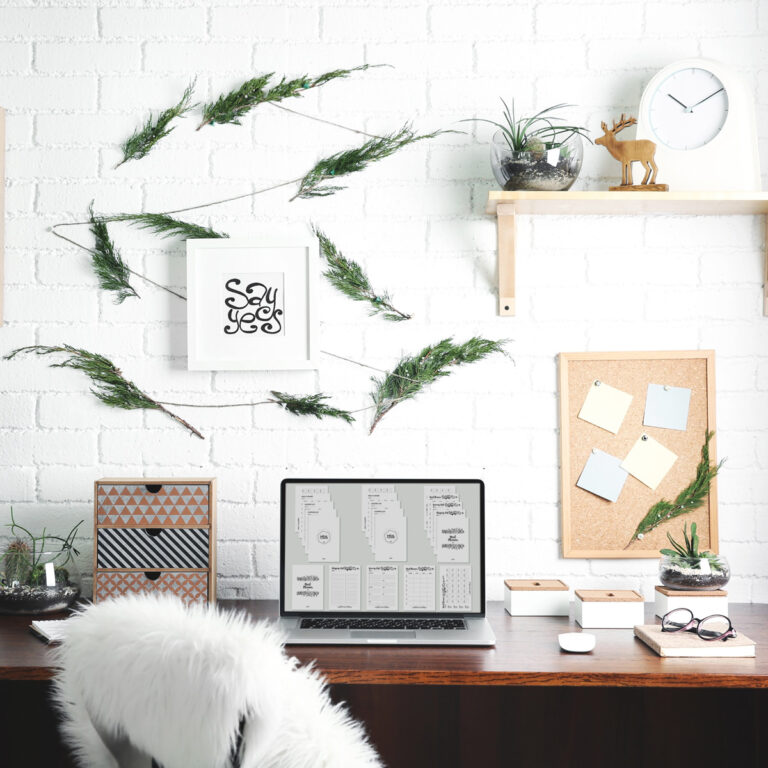 Modern laptop on wooden desk with digital products on screen