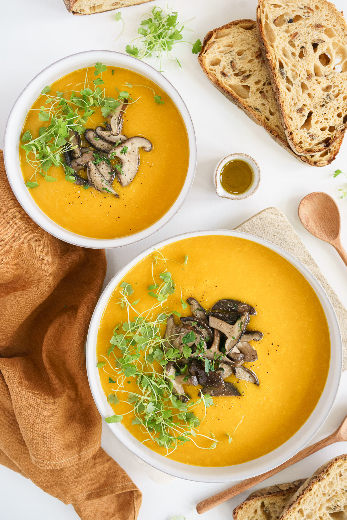 top view of the two serving bowls with full of pumpkin soup