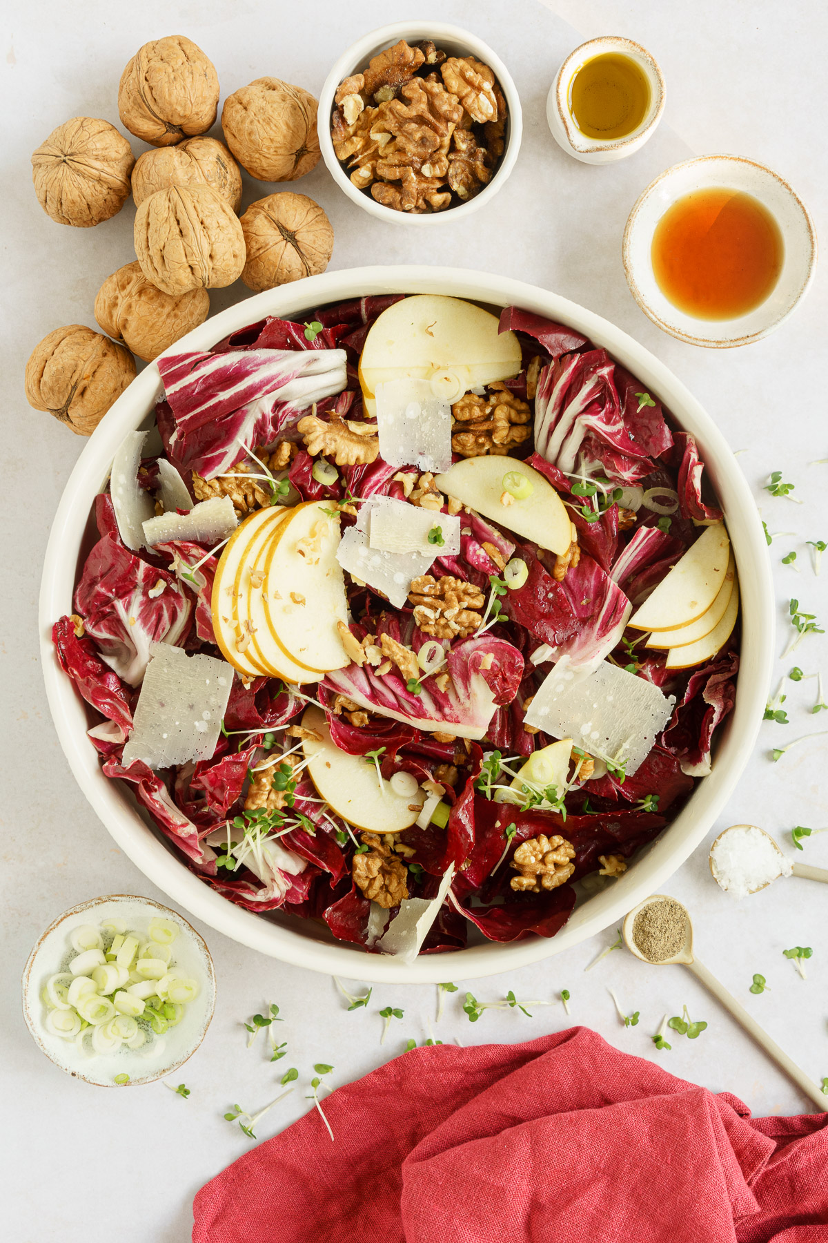 top view of radicchio salad in a bowl with cheese and spring onions on the side