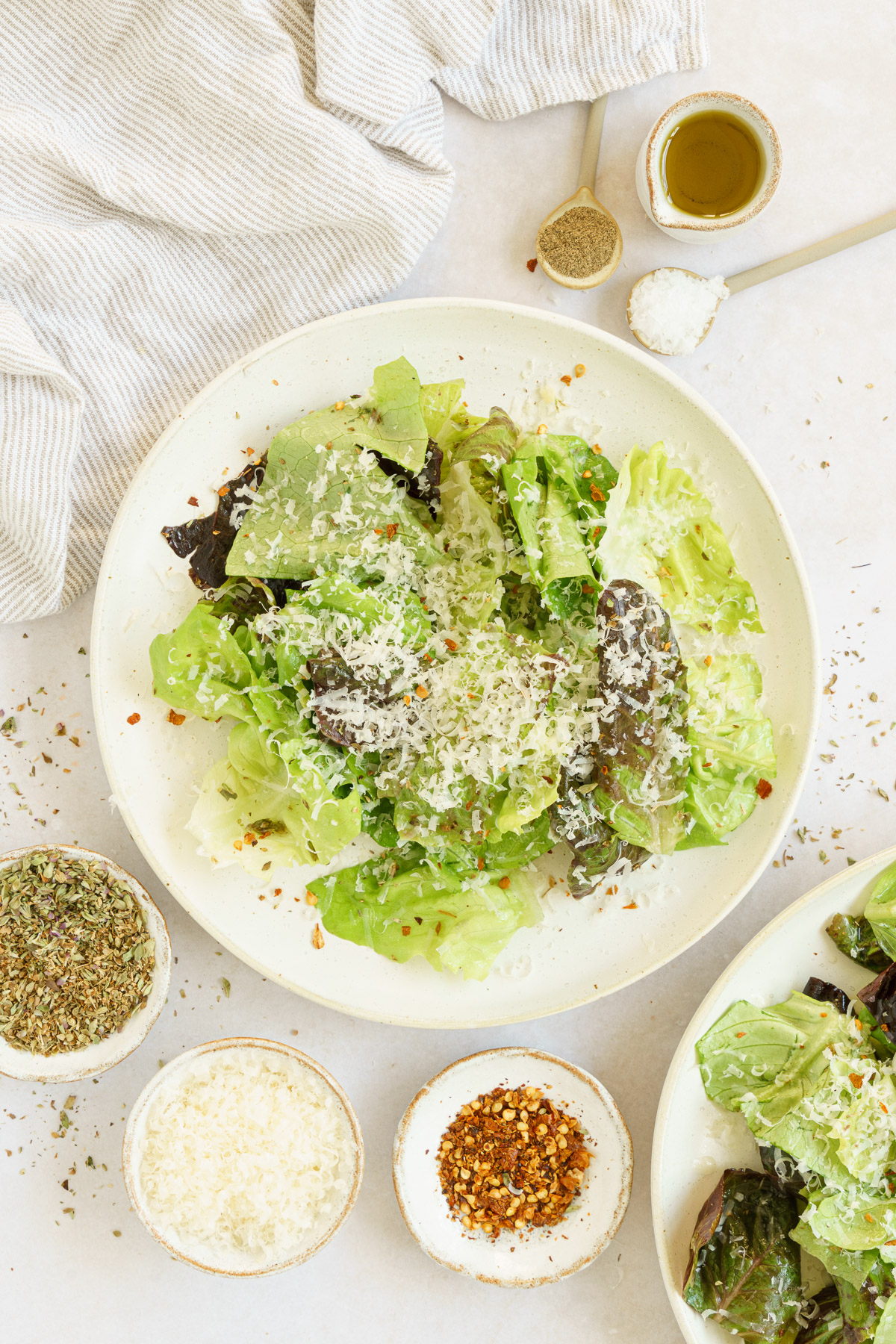 top view of a full plate of lettuce salad with dressing ingredients
