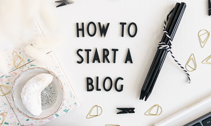 letters saying "how to start a blog" on a white desk