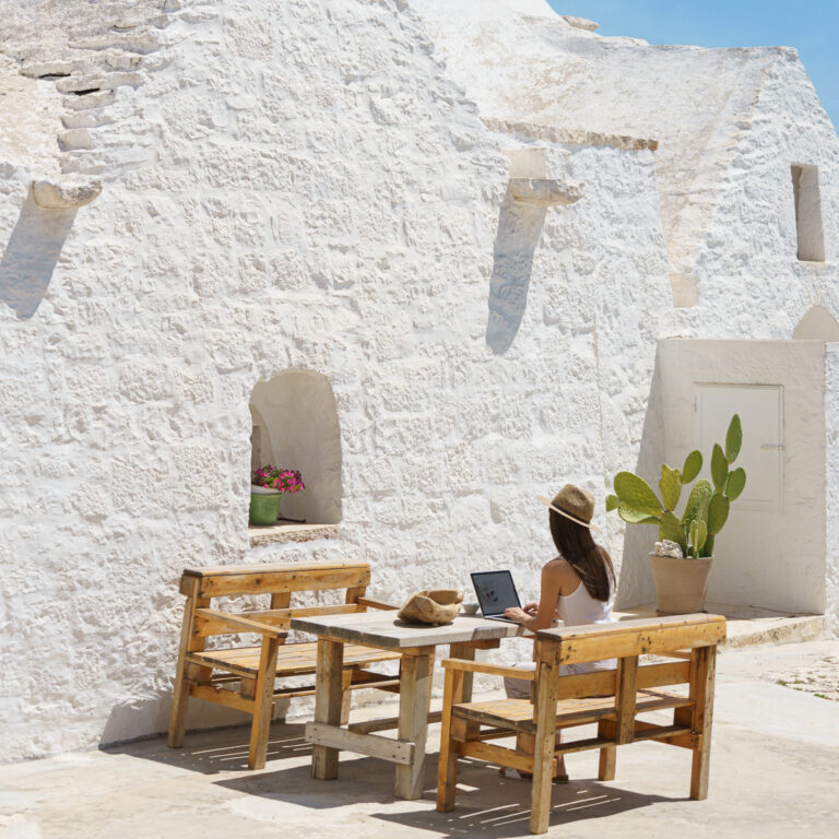 Woman working on a laptop in the sun