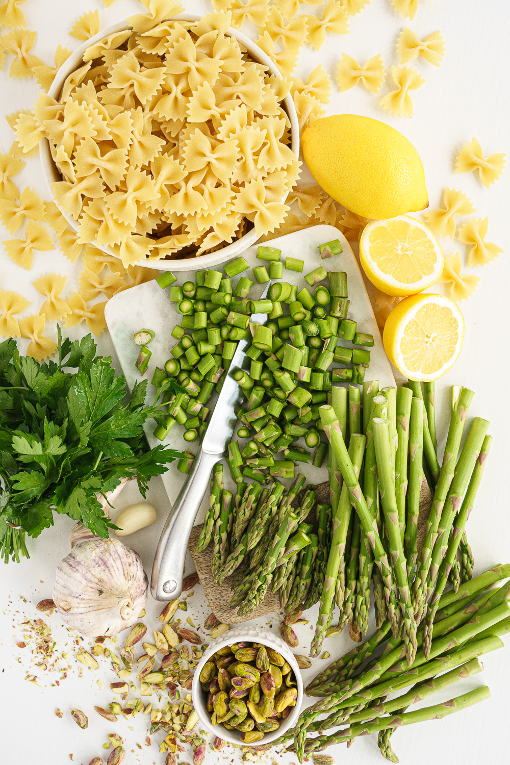 Top view of ingredients needed for asparagus pesto pasta