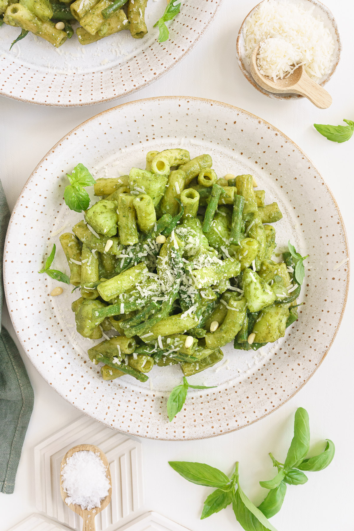 Top view of basil pesto pasta with cheese