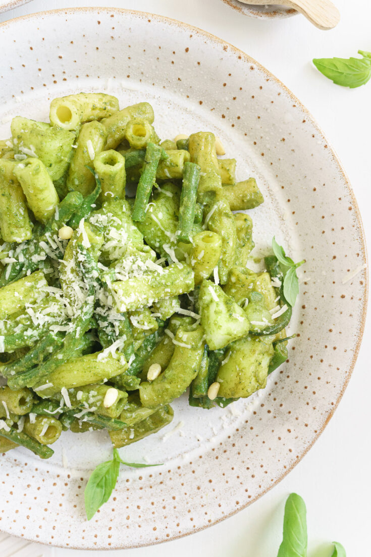 Close up view of a plate of basil pesto pasta