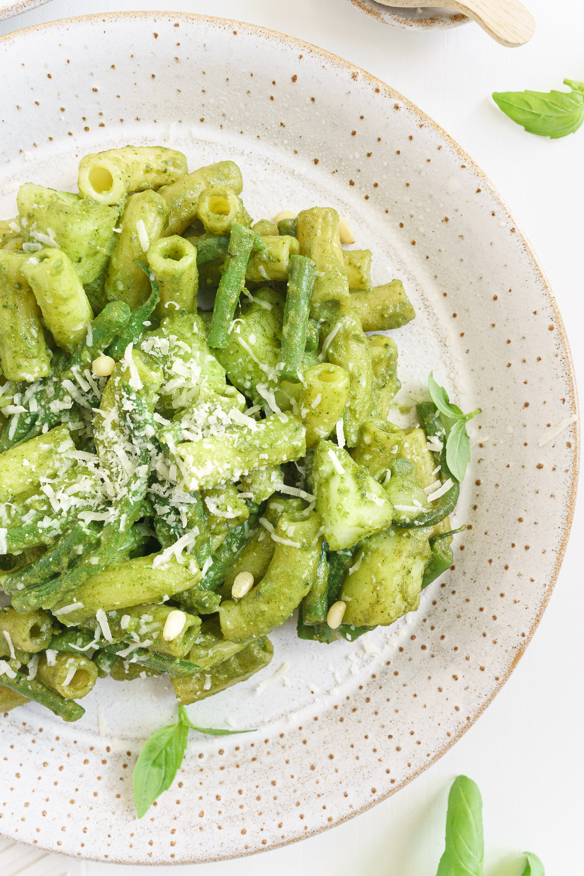 Close up view of a plate of basil pesto pasta