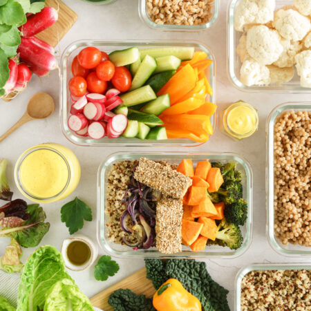 Lots of meal prep containers filled with ingredients