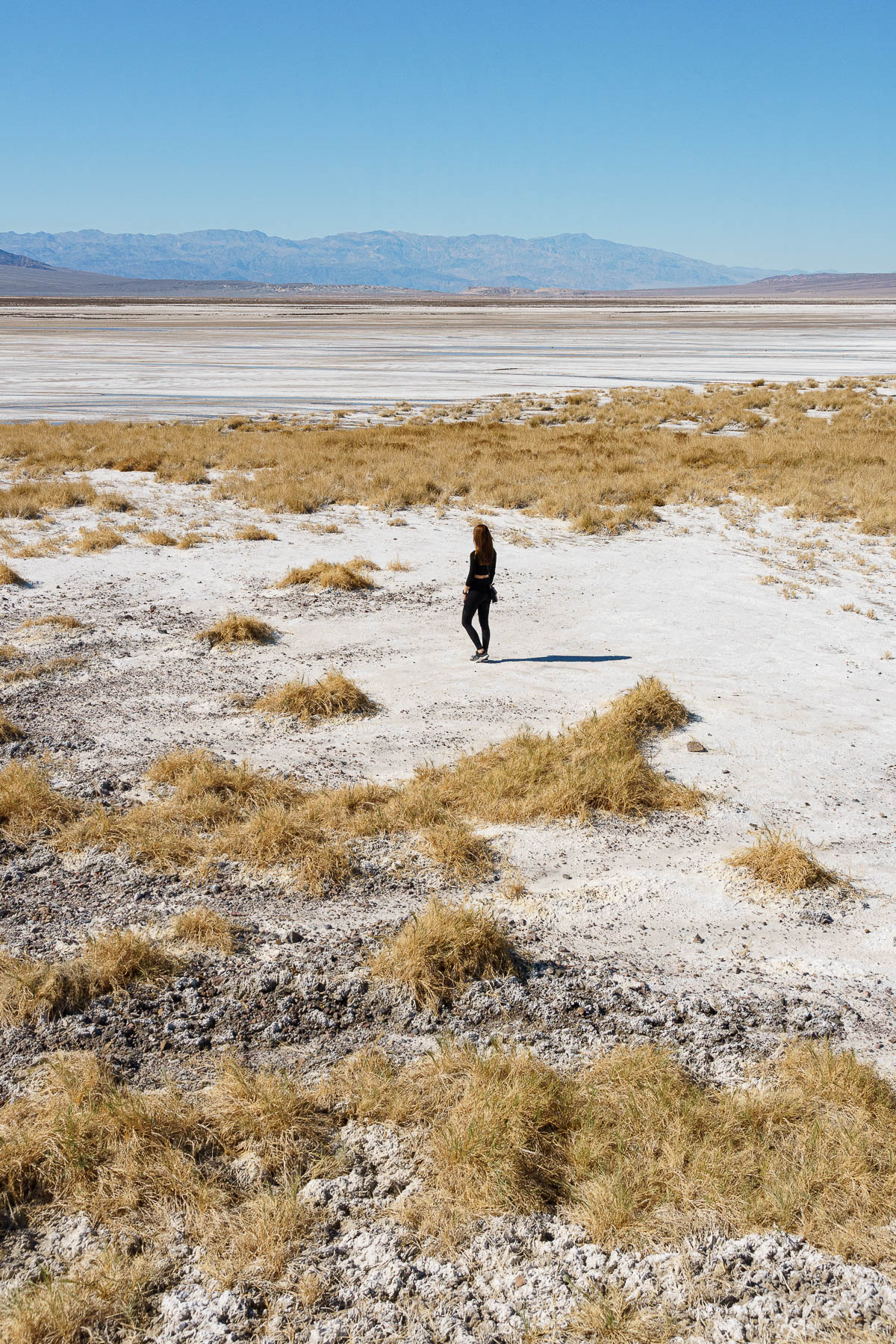 Woman admiring the flat landscape of the death valley