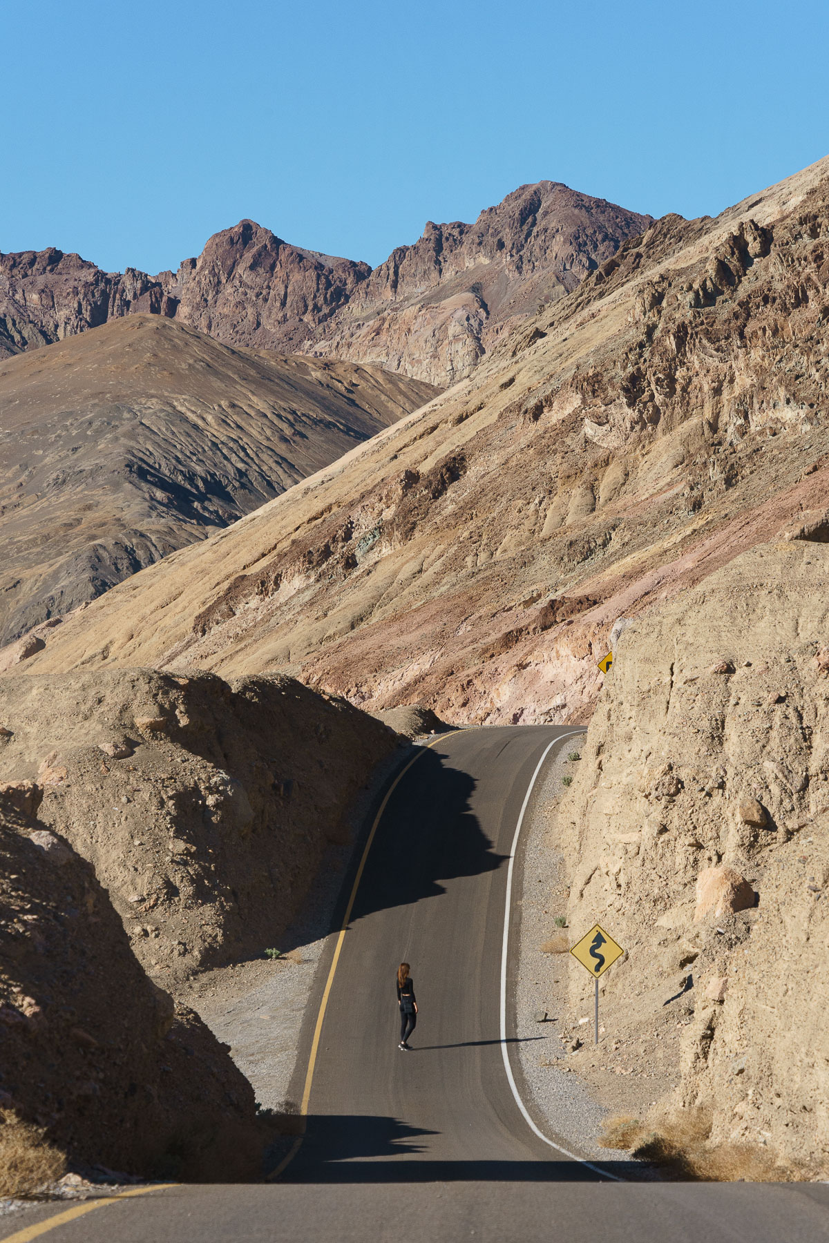 Woman looking at the horizon in the middle of the road