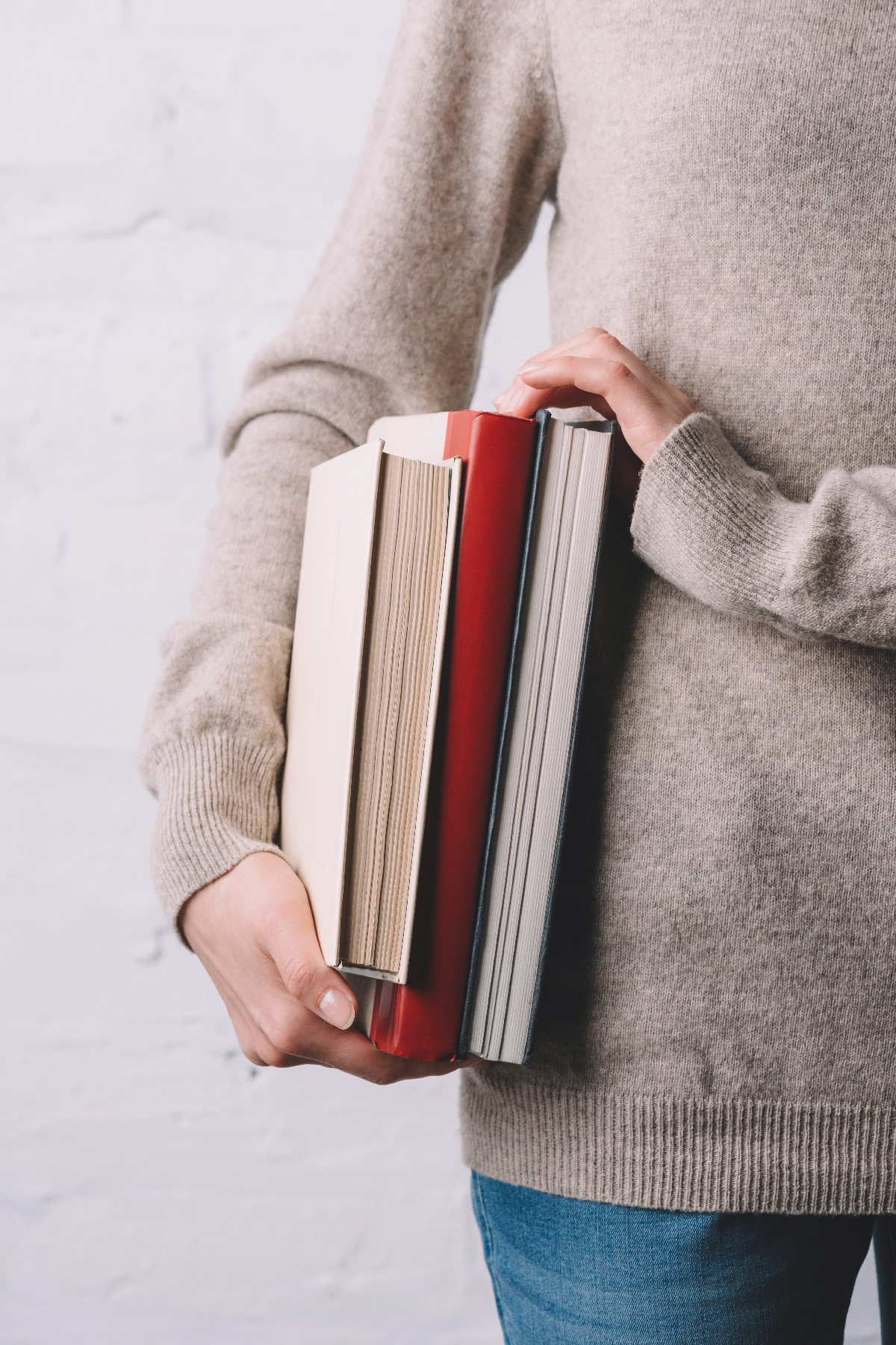 Woman holding financial literacy books in her hands