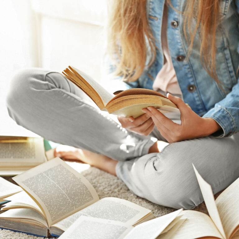 Woman reading books about How to Make Money