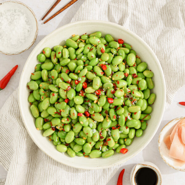 close up of plate filled with salt and chili edamame