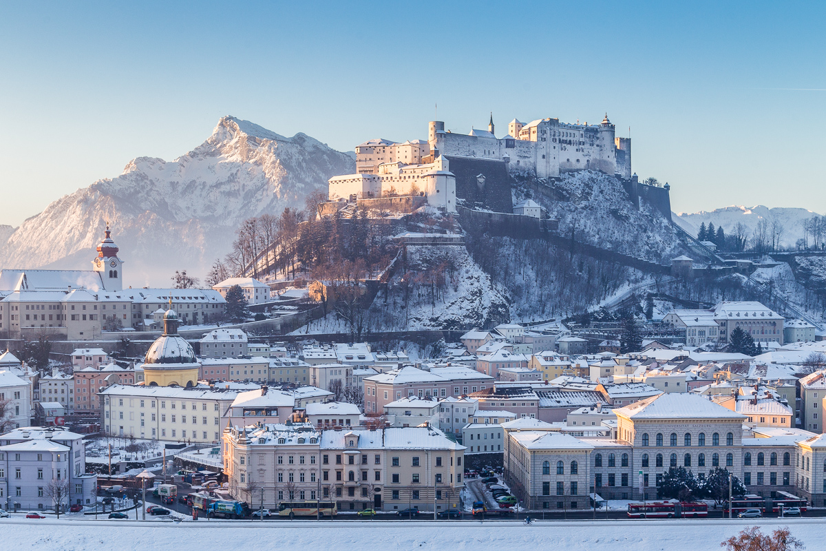 Classic view of the historic city of Salzburg with famous Hohensalzburg Fortress and Salzach river in scenic morning light 