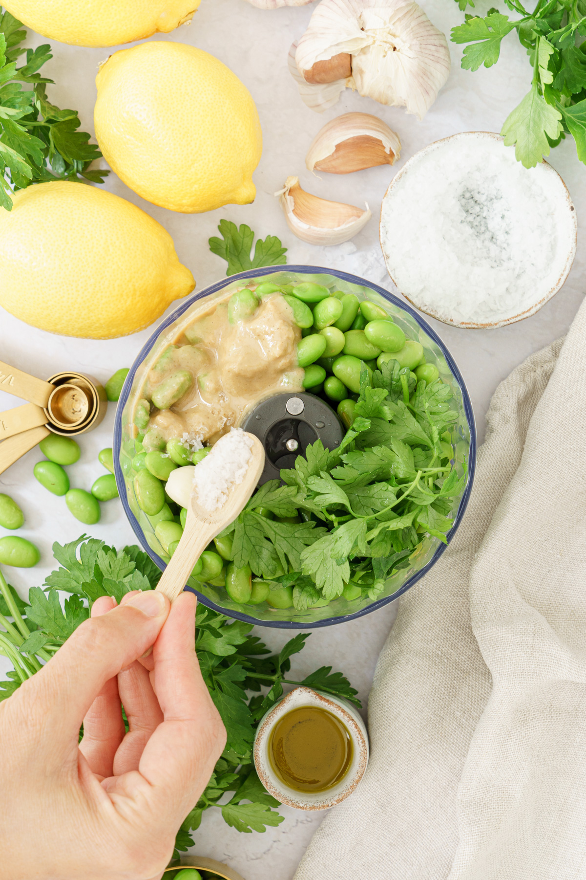 top view image of edamame hummus ingredients combine in a blender