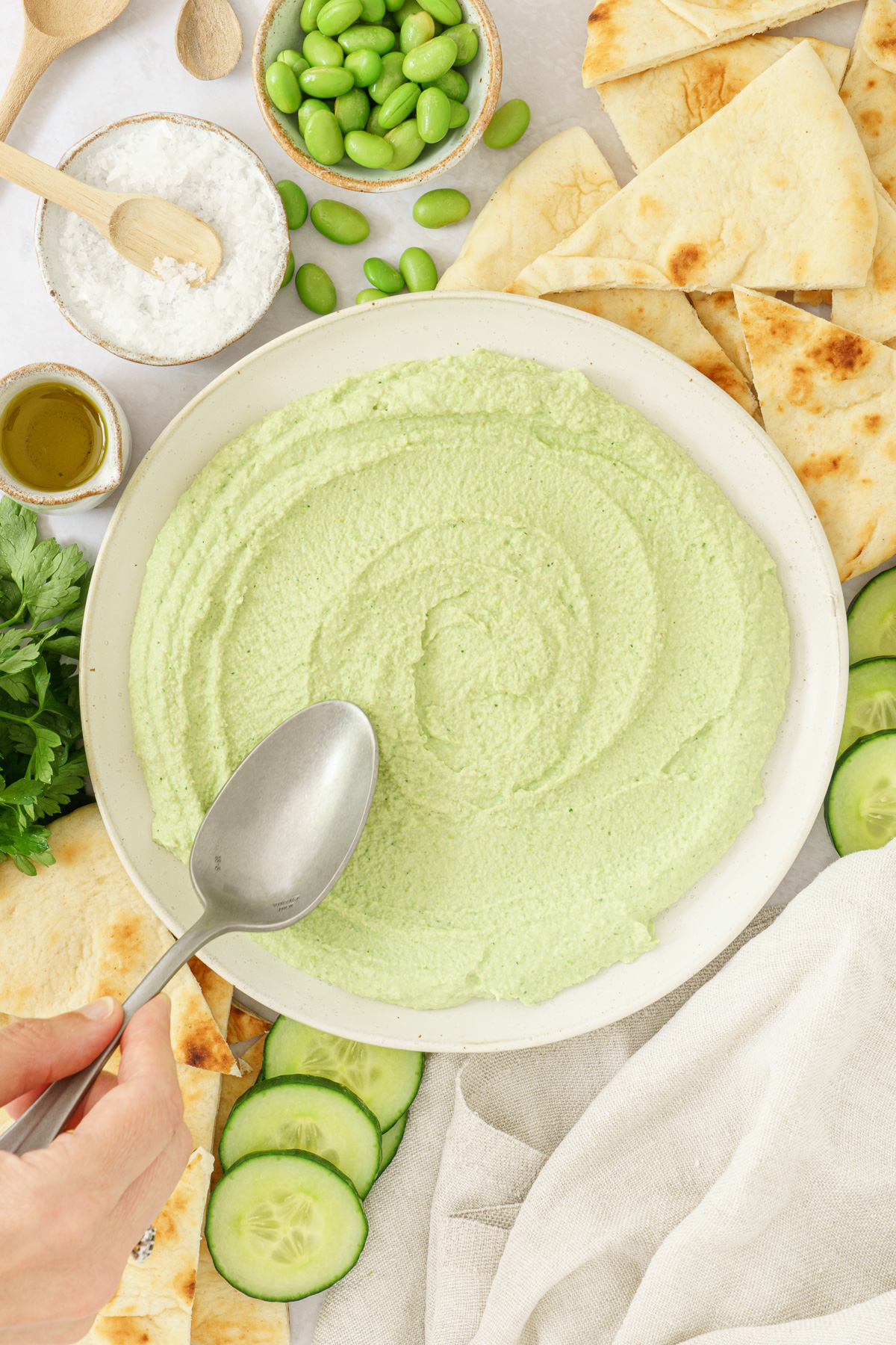 top view image of an edamame hummus in a round bowl