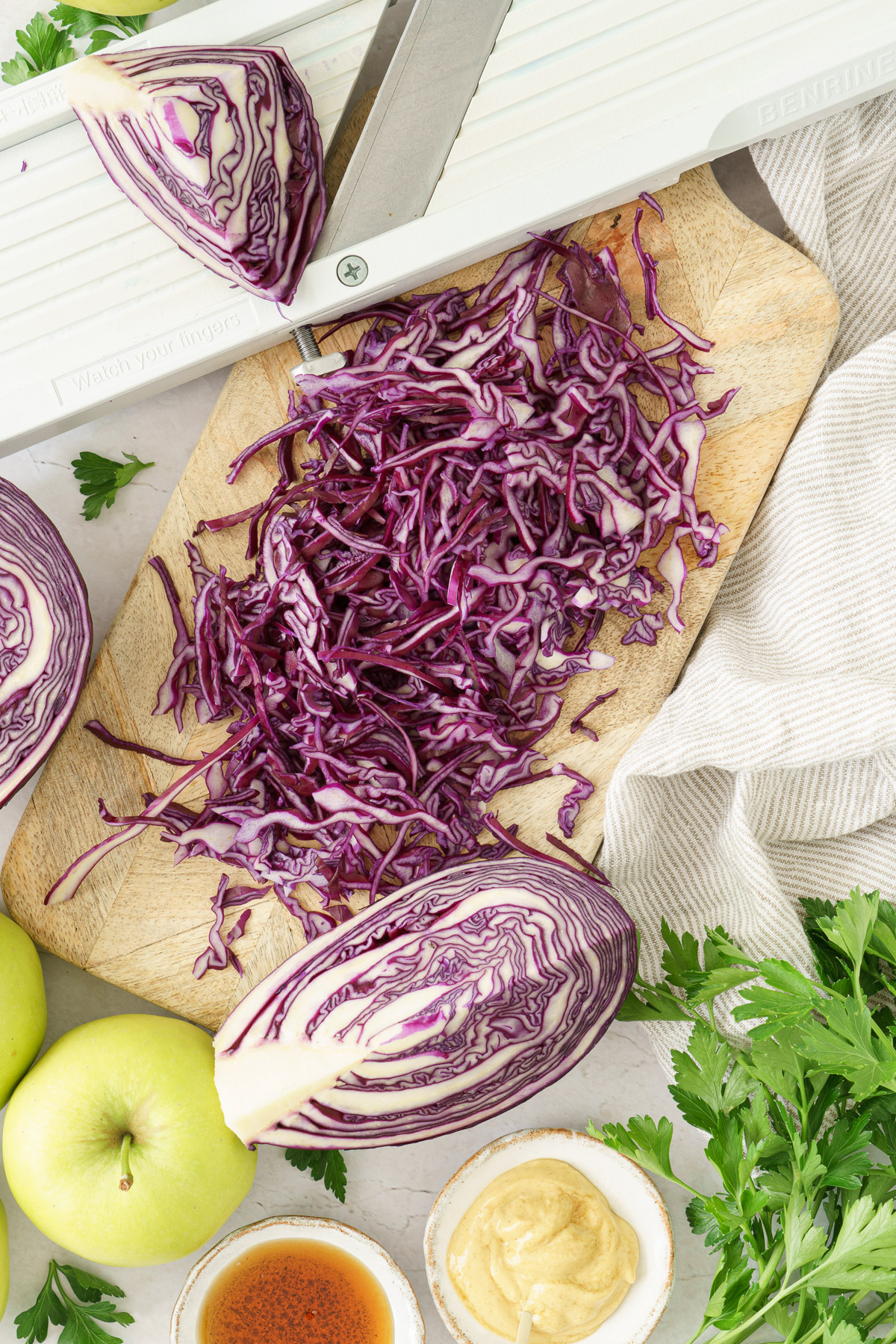 top image of a thinly sliced red cabbage on top of the chopping board