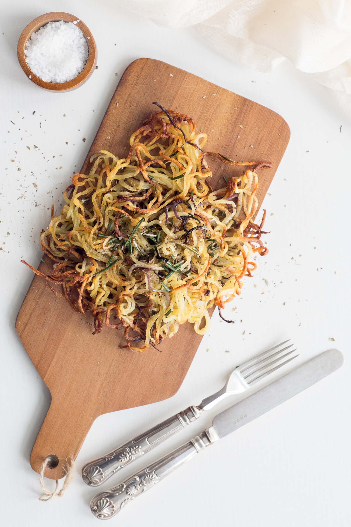 Top down view of spiralized potatoes on a wood board