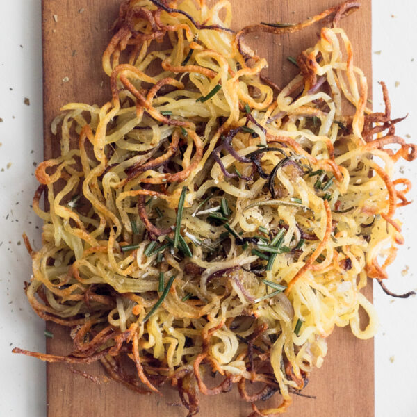 Top down view of spiralized potatoes on a wood board