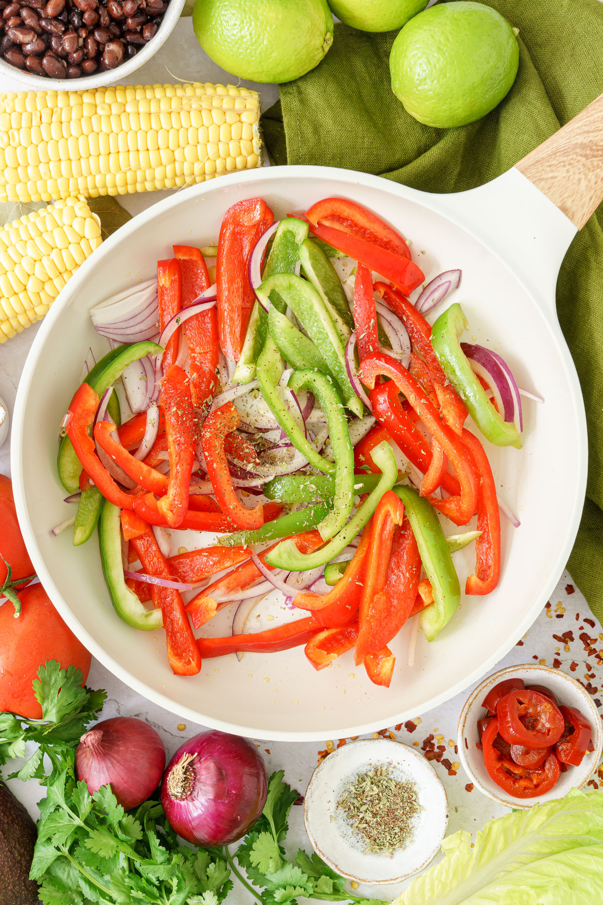 frying pan with bell peppers, onions, and oregano 