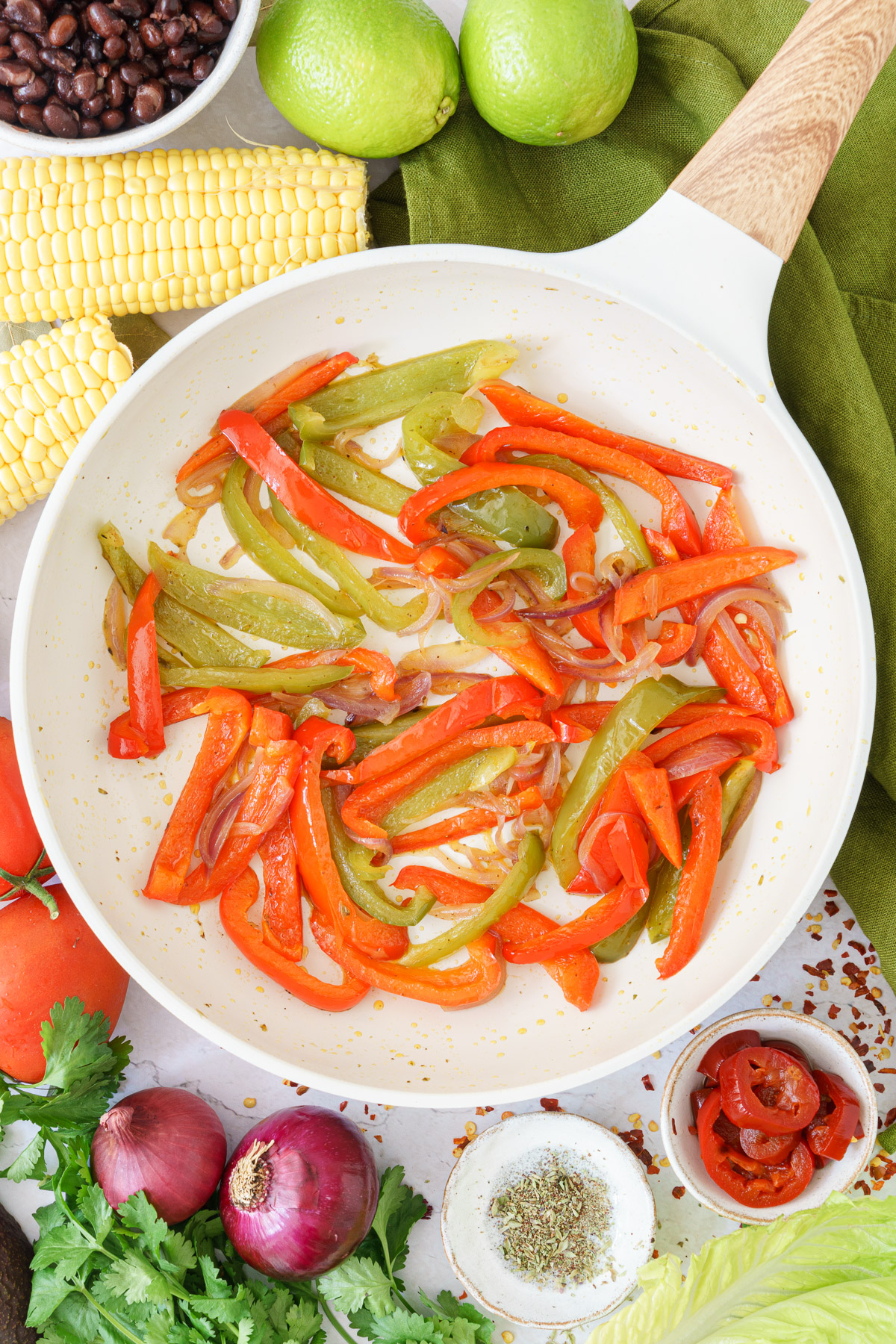 frying pan with tender bell peppers, and onions