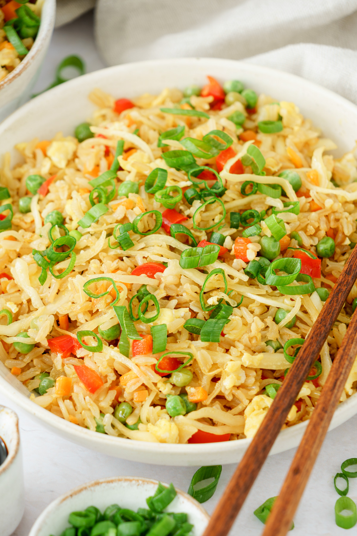 close up image of a bowl full of delicious and colorful fried rice top with spring onions