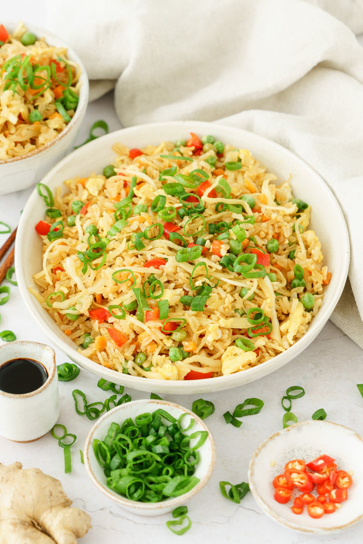 close up image of a bowl full of delicious and colorful fried rice top with spring onions