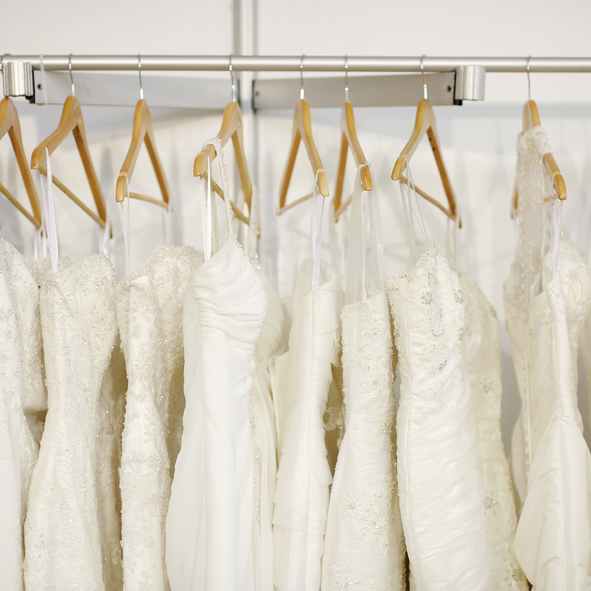 image of white wedding dresses on the rack