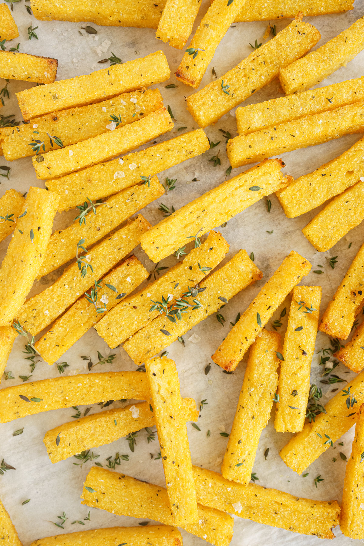 Close up of baked polenta fries on a baking tray