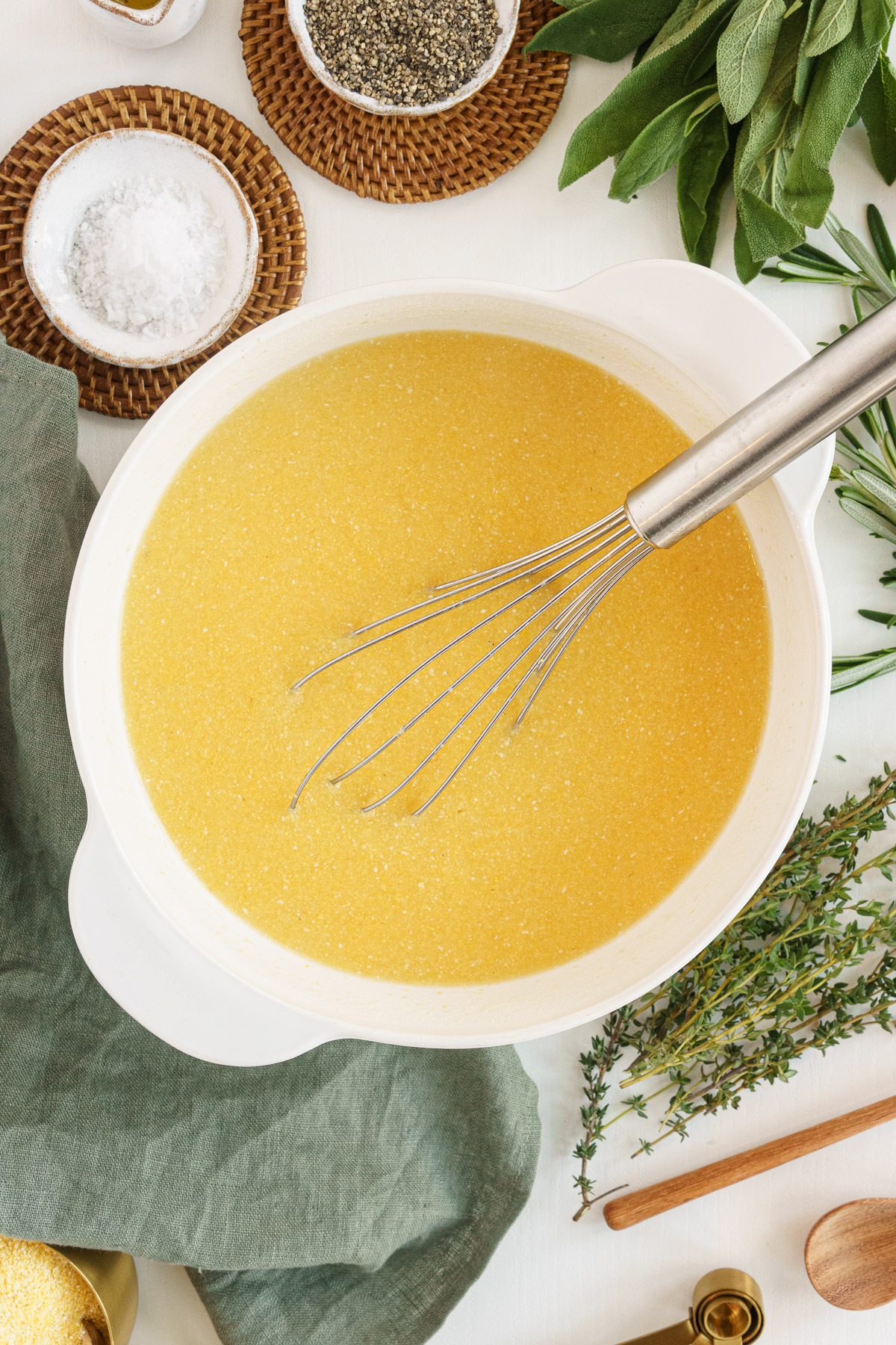 stirring polenta with a whisk