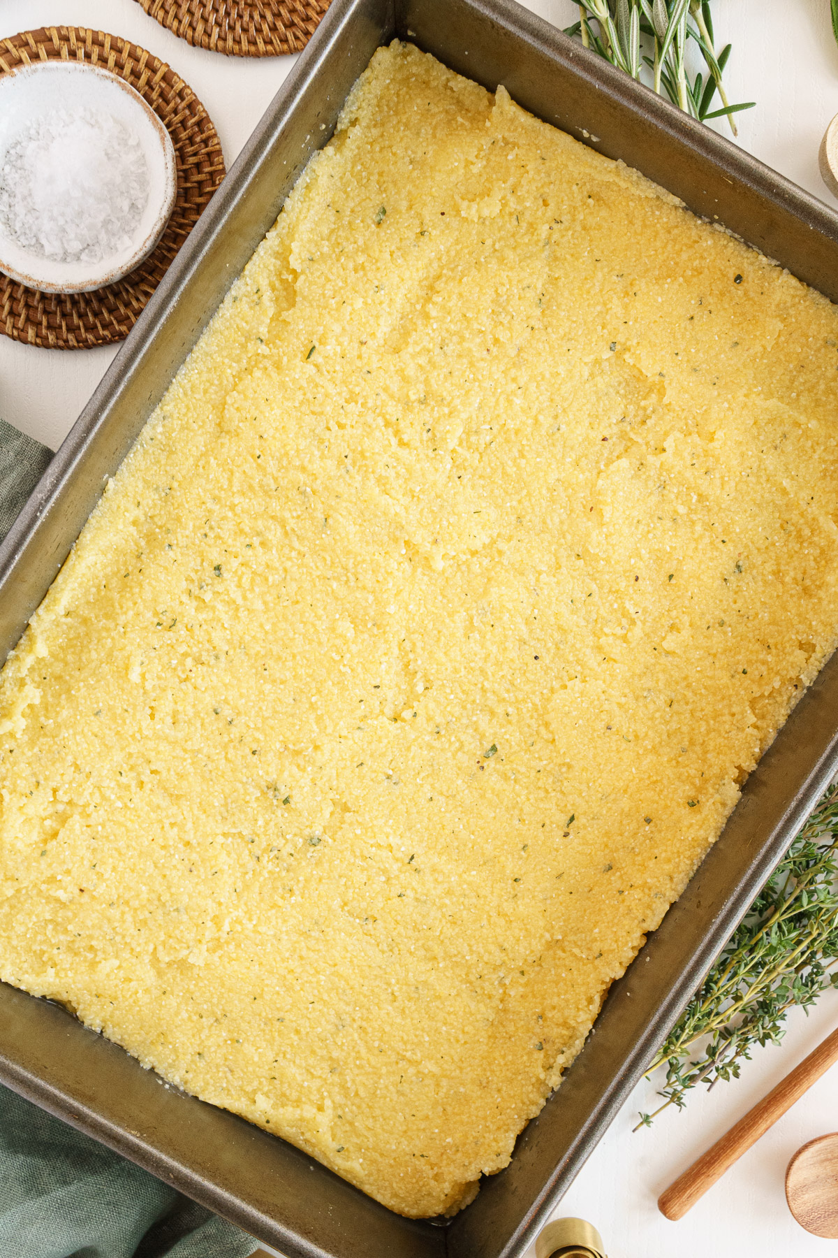 Polenta spread in even layer on a greased baking dish