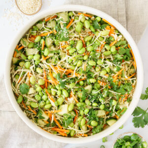 top down view image of a bowl brimming with vibrant edamame salad
