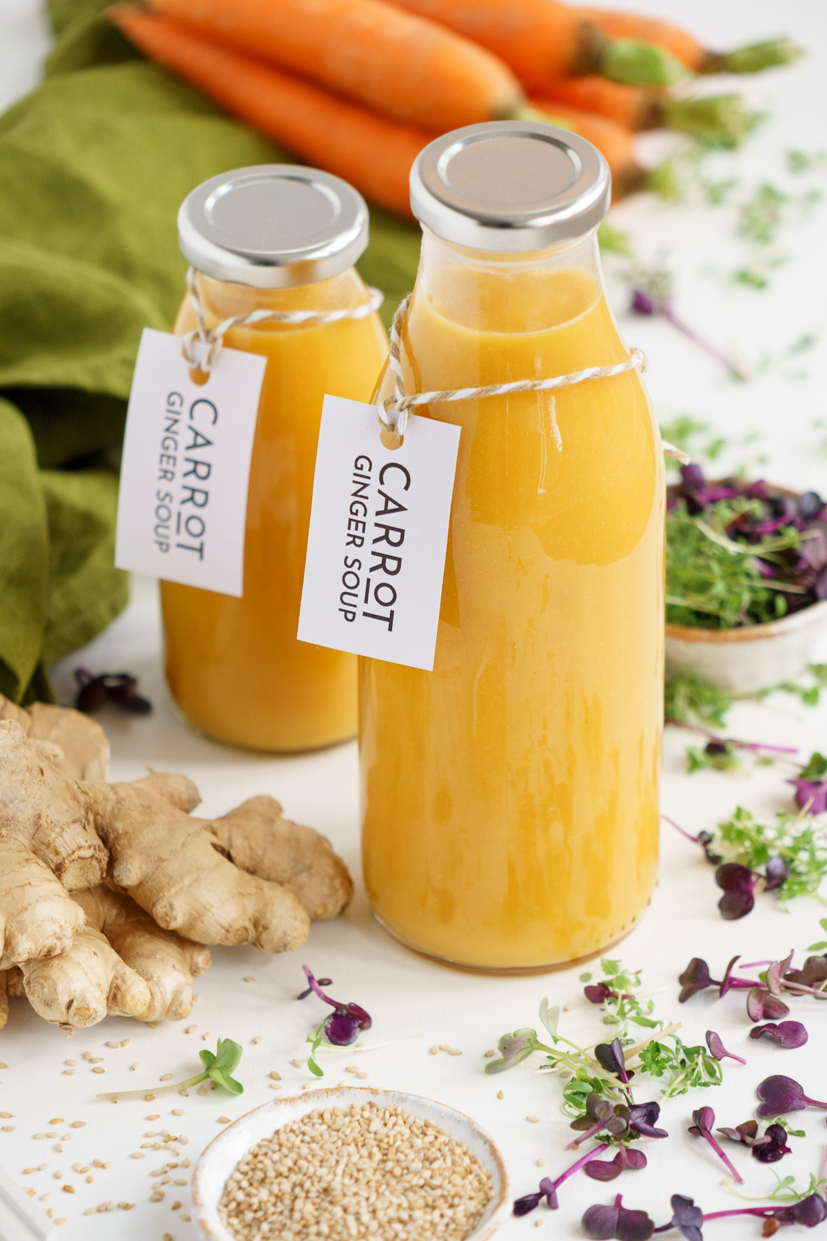 Vegan carrot ginger soup in glass bottles