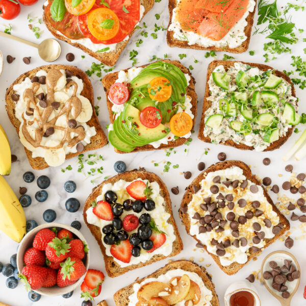 Cottage cheese toast variations: tomato and basil, avocado, cherry tomatoes, and chili flakes, smoked salmon and dill, tuna and cucumber berries, lemon, and honey, banana and almond butter, cinnamon and caramelized apple, and chocolate chips, nuts, and maple syrup.