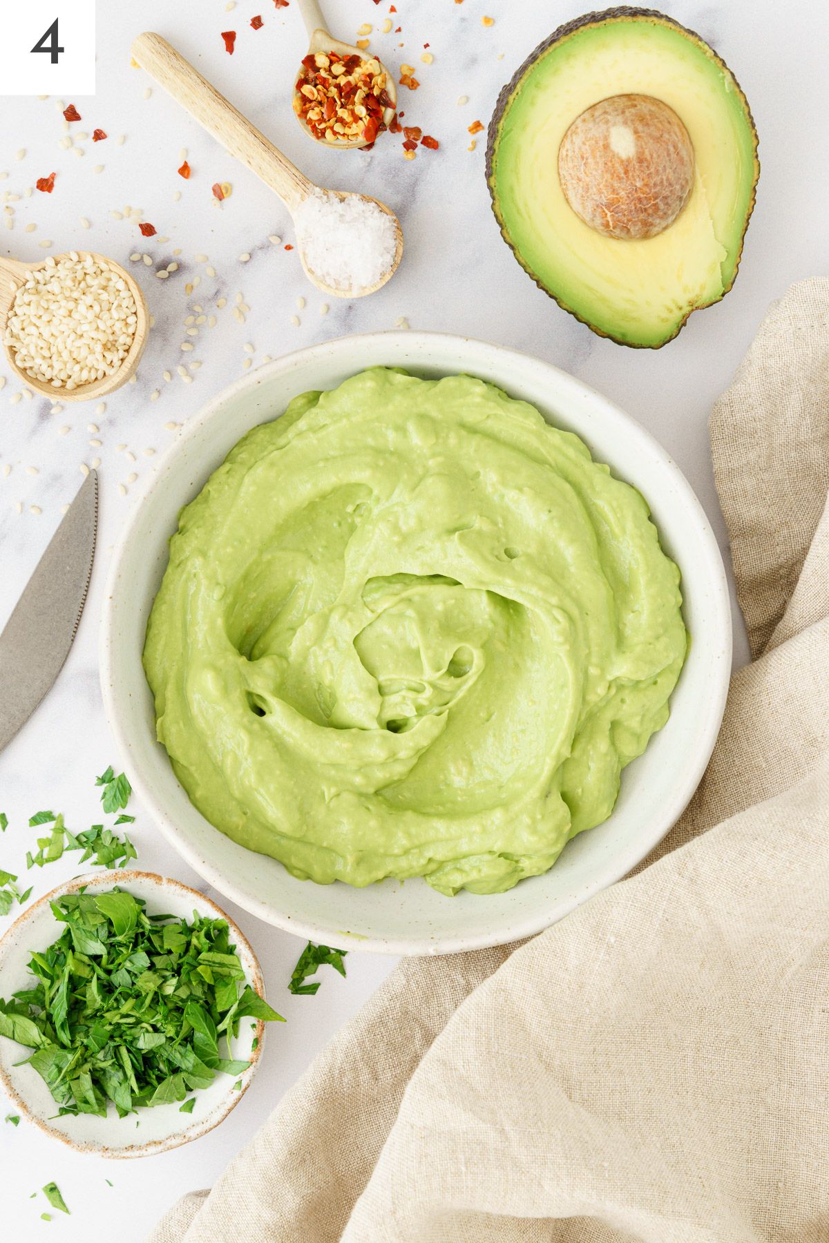 Bowl filled with mashed avocados.