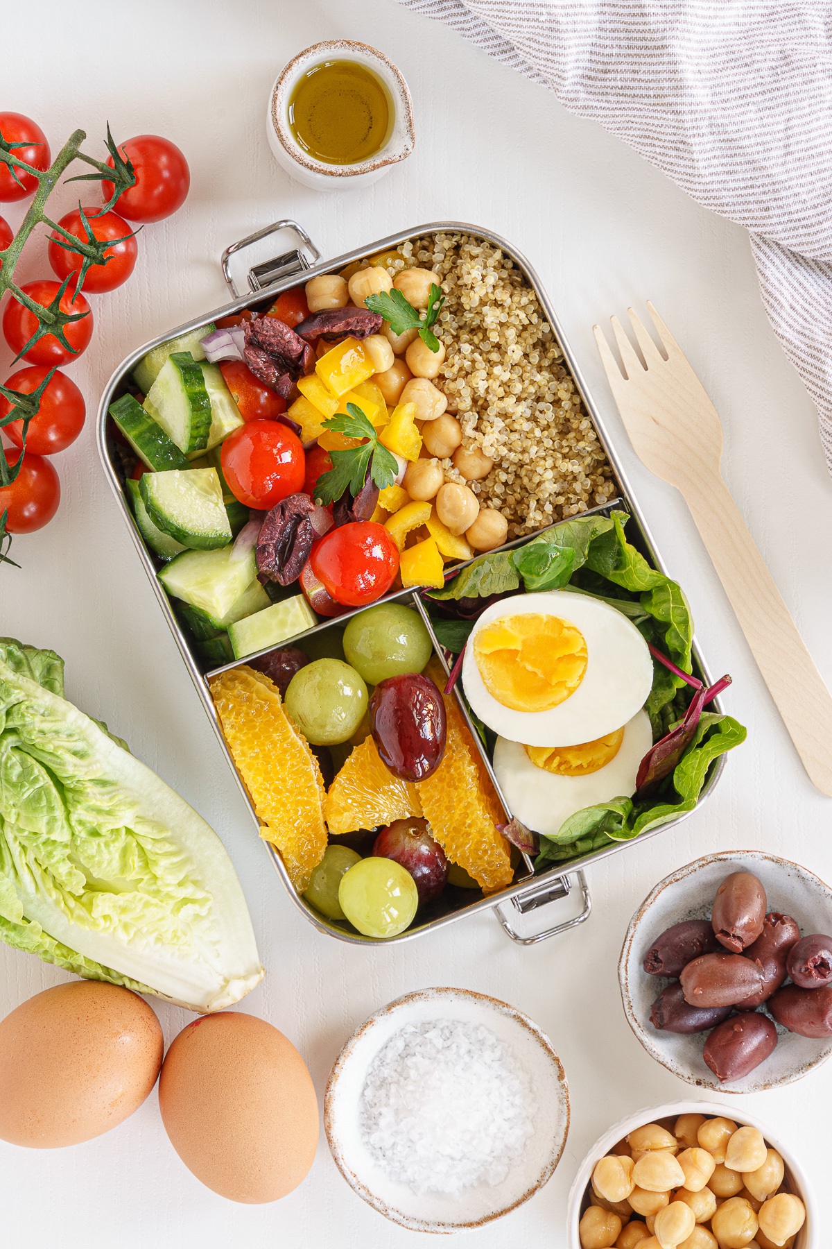 Bento box with eggs, salad and fruit.