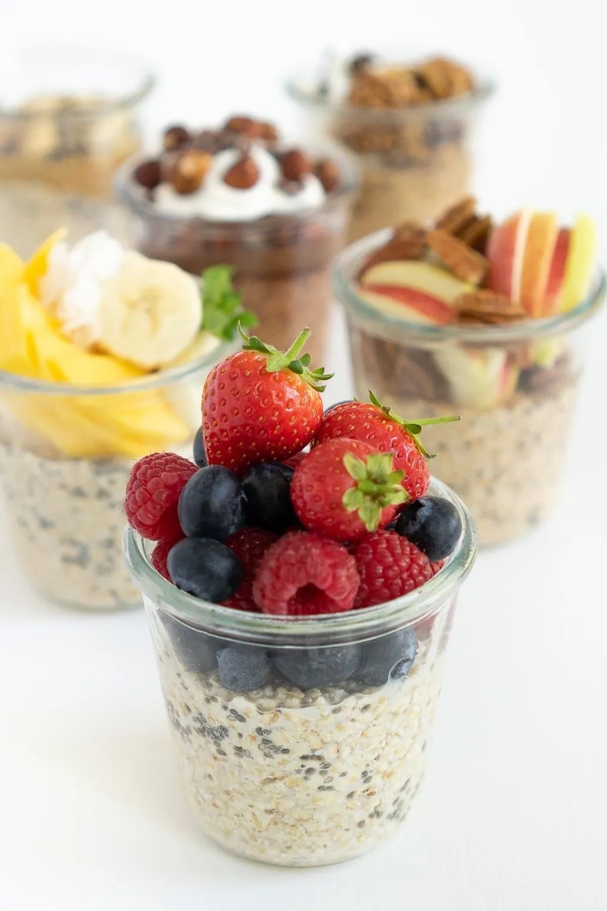 jars filled with overnight oats with various different flavors.