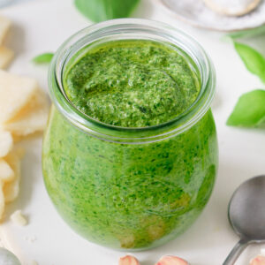 Jar filled with homemade nut free pesto sauce.