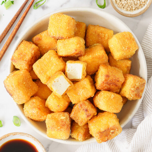 A bowl full of cube fried tofu.