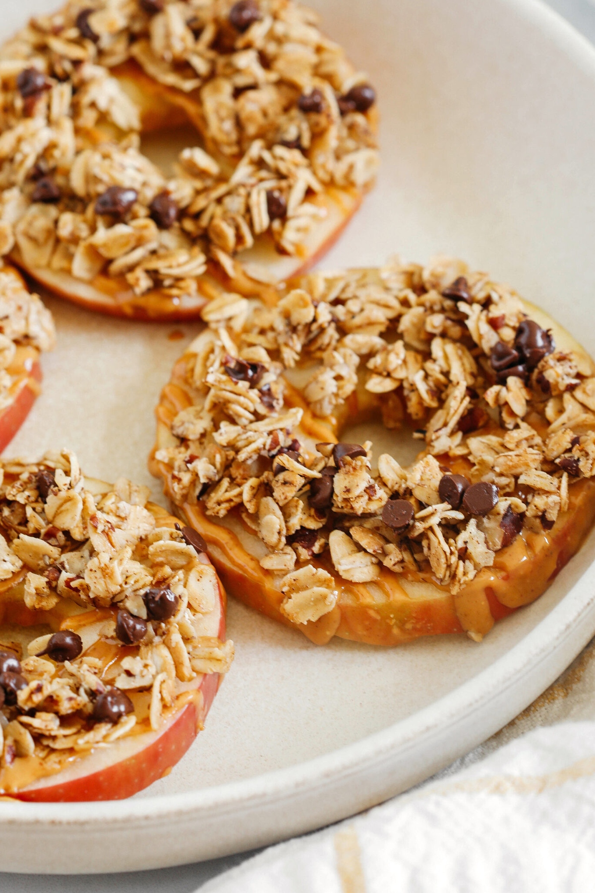 Peanut butter granola apple rings on a baking sheet.