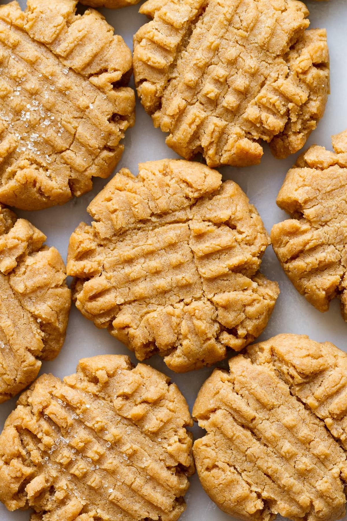 Peanut butter cookies laid on a baking tray.